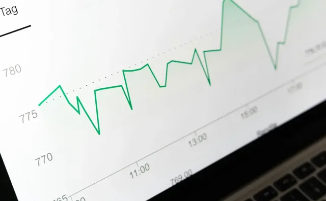 Market data traced as a rising green line on an analyst's screen