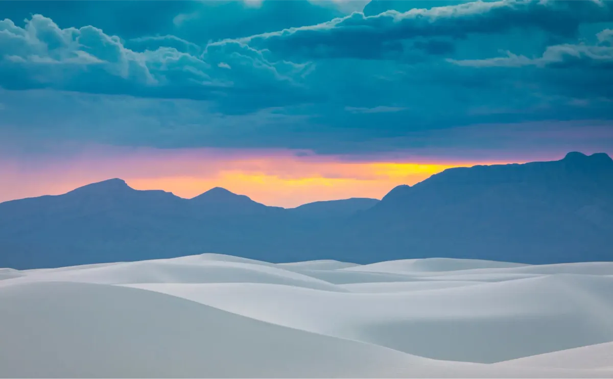 A pale dune landscape under a soft gradient sky, used as an immersive environment